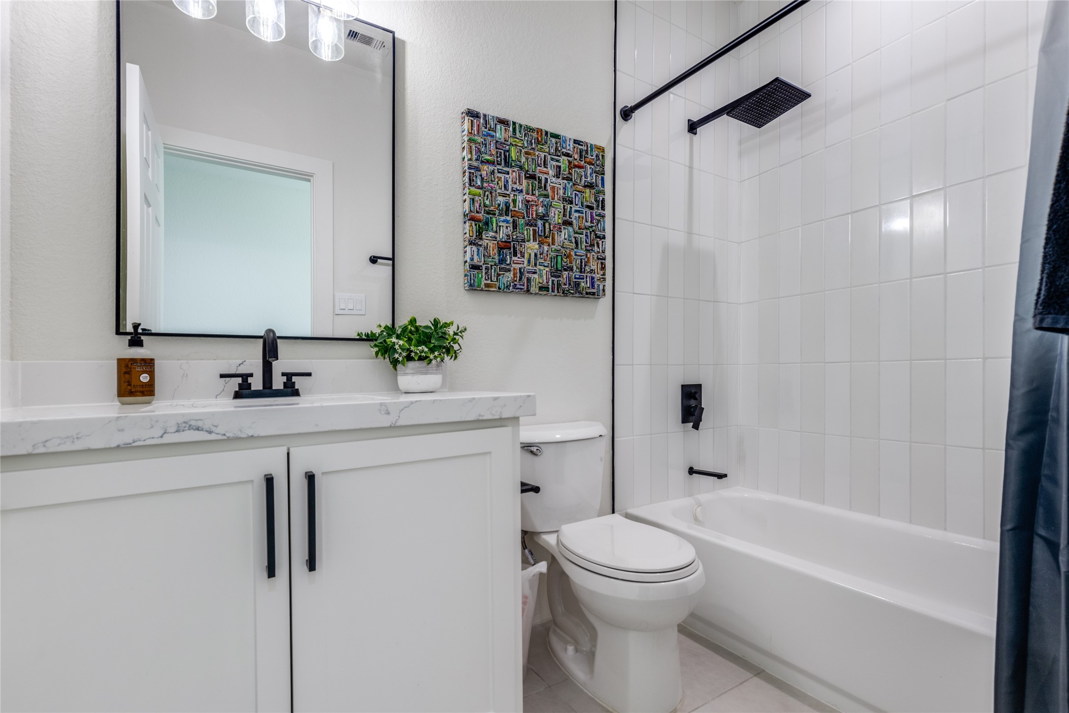 5618 Canal Street Houston, TX 77011 - Photo 7 of 12 Bathroom is situated between the two bedrooms upstairs. Beautiful Quartz countertop. Rain shower head for those relaxing showers.