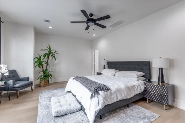 a bedroom with a bed and ceiling fan
