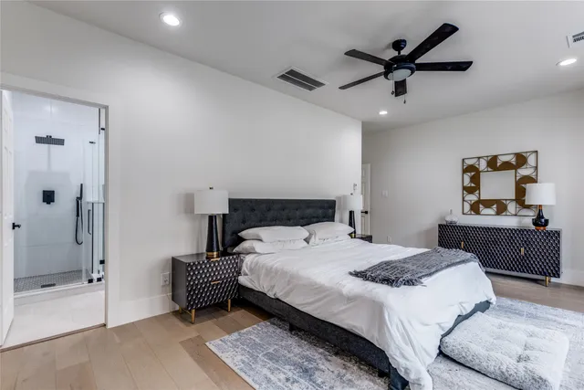 a bedroom with a large bed and a chandelier