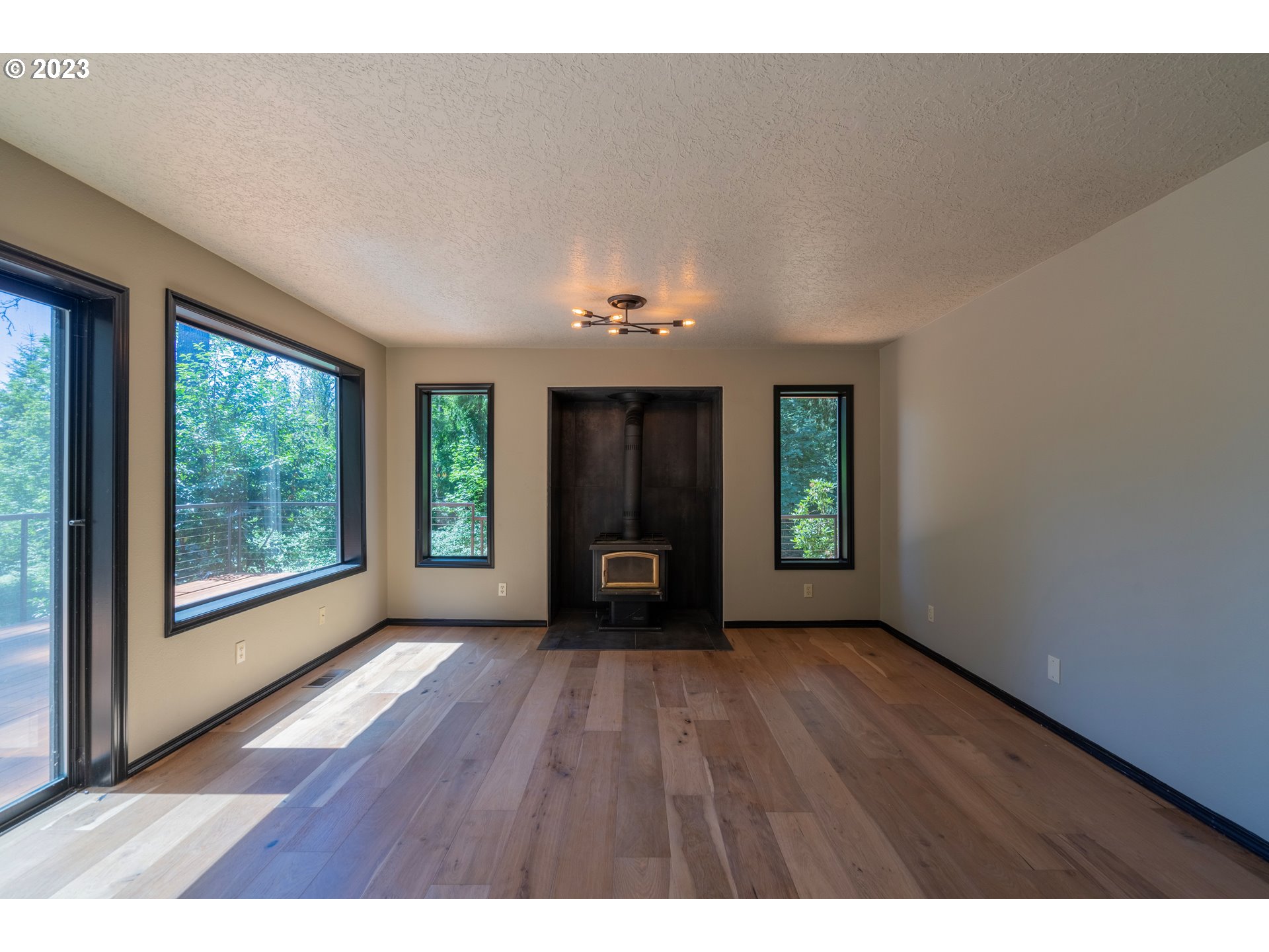 19040 South Mattoon Road Estacada, OR 97023 - Photo 15 of 46 a view of an empty room with wooden floor and a window