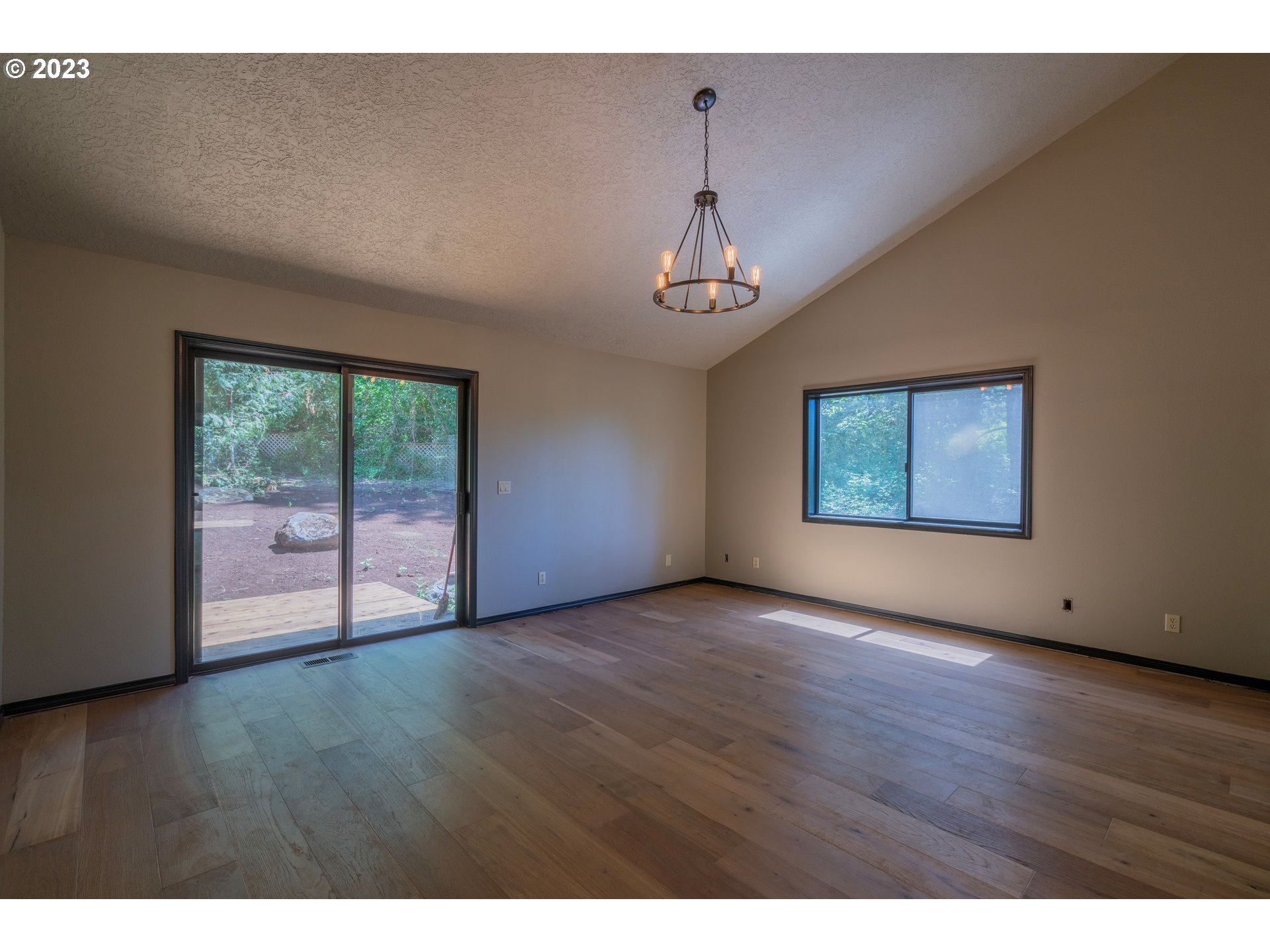 19040 South Mattoon Road Estacada, OR 97023 - Photo 16 of 46 a view of an empty room with a window and wooden floor
