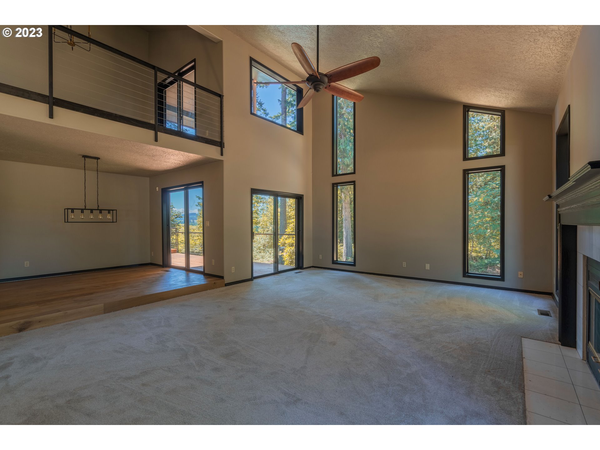 19040 South Mattoon Road Estacada, OR 97023 - Photo 9 of 46 a view of a big room with windows and chandelier