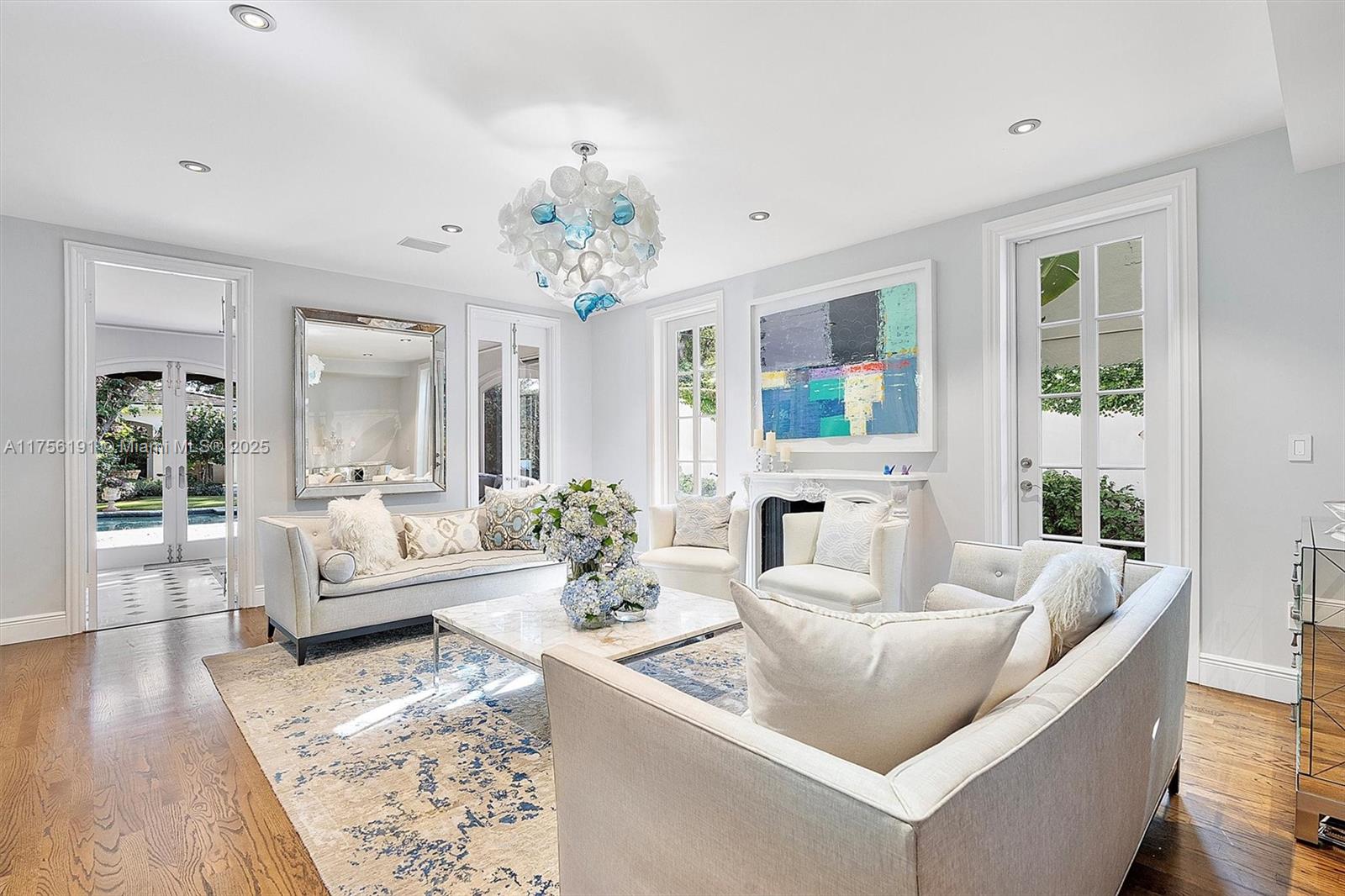 524 Hardee Road Coral Gables, FL 33146 - Photo 12 of 48 a living room with furniture and a chandelier