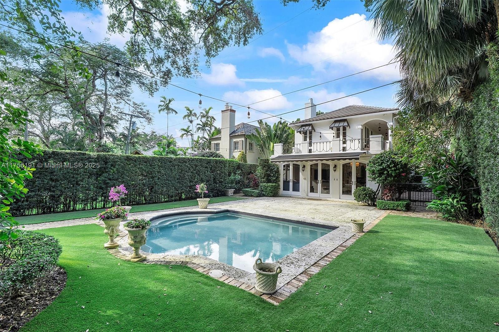 524 Hardee Road Coral Gables, FL 33146 - Photo 2 of 48 a view of pool with lawn chairs and large trees