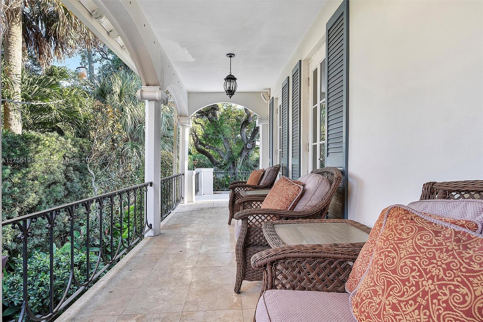 524 Hardee Road Coral Gables, FL 33146 - Photo 42 of 48 a balcony view with a couch and wooden floor