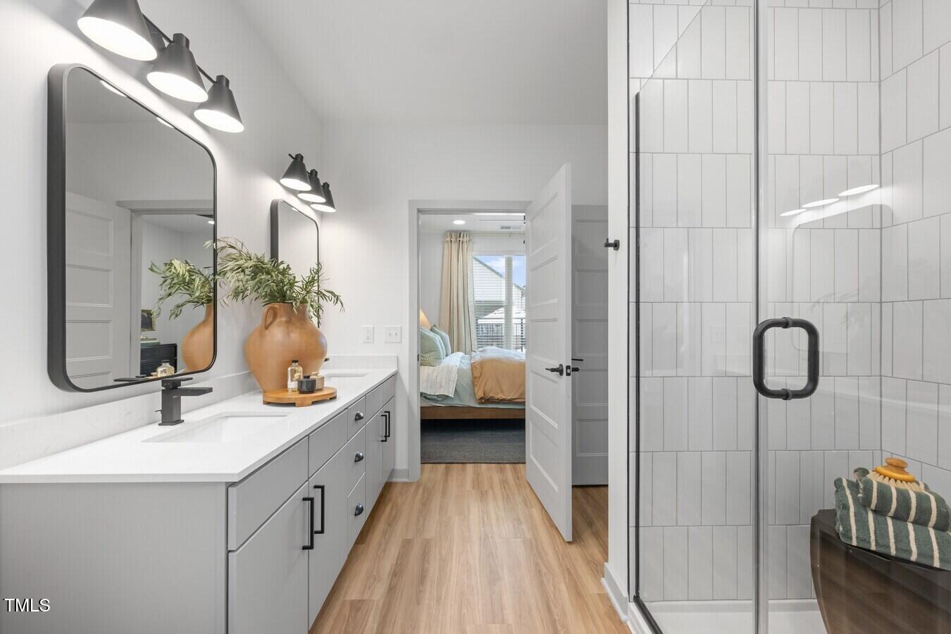 3901 Capital Hills Drive, Unit C1A Raleigh, NC 27616 - Photo 21 of 35 a en suite bathroom with a double vanity sink a mirror and shower