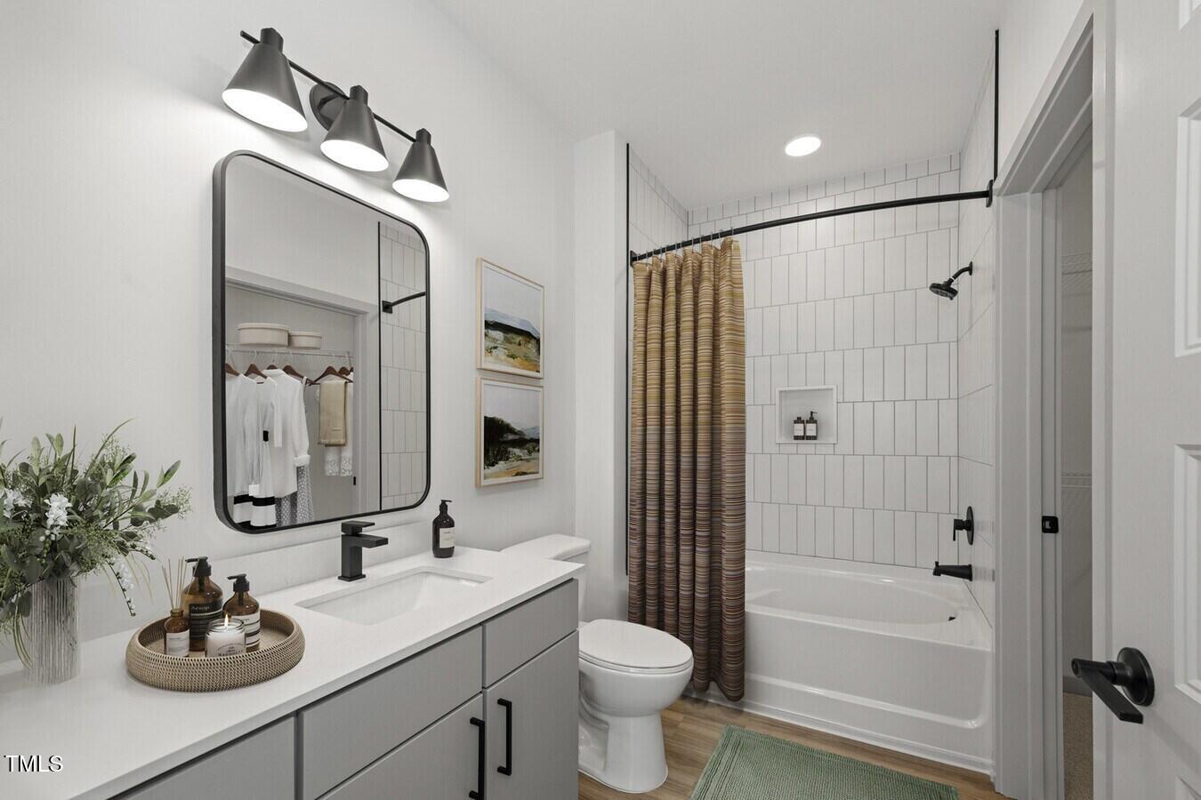 3901 Capital Hills Drive, Unit C1A Raleigh, NC 27616 - Photo 25 of 35 a bathroom with a sink a toilet and shower