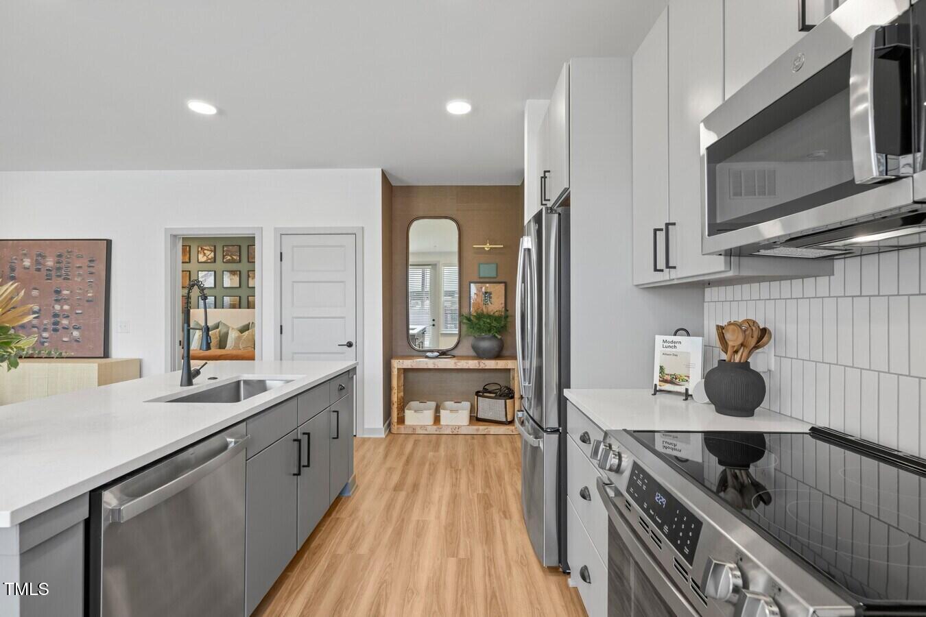 3901 Capital Hills Drive, Unit C1A Raleigh, NC 27616 - Photo 30 of 35 a kitchen with stainless steel appliances granite countertop a stove and a sink