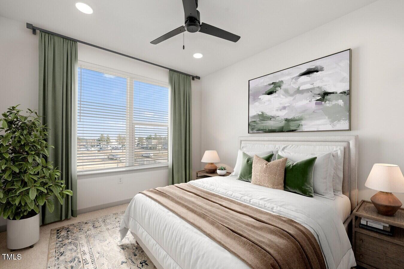 3901 Capital Hills Drive, Unit C1A Raleigh, NC 27616 - Photo 31 of 35 a bedroom with a large bed and a potted plant