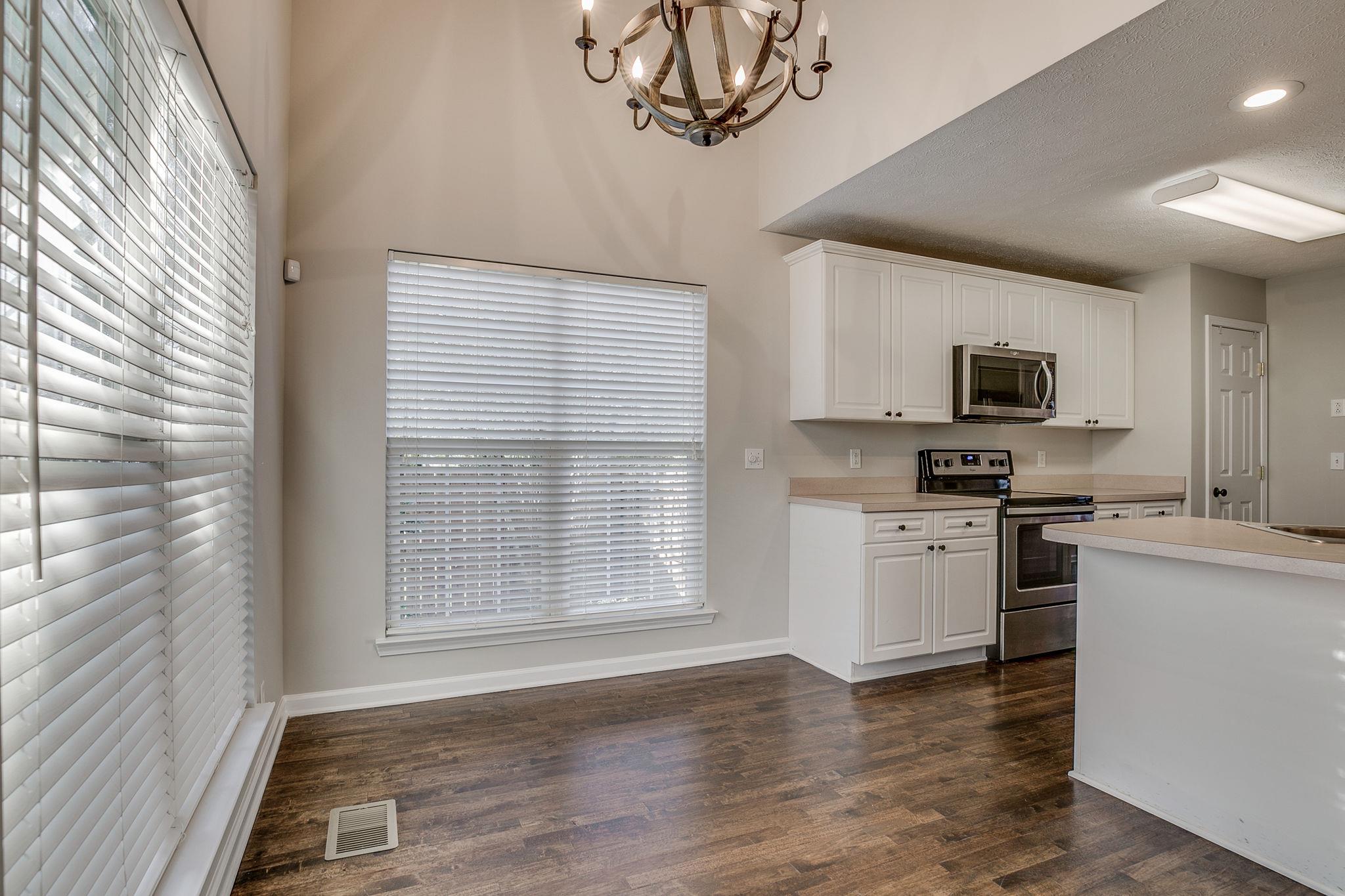 391 Abbie Road Murfreesboro, TN 37128 - Photo 11 of 30 a kitchen with a stove a sink and a microwave