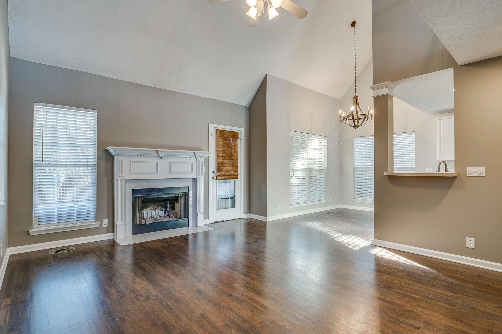 391 Abbie Road Murfreesboro, TN 37128 - Photo 9 of 30 a view of an empty room with wooden floor fireplace and a window