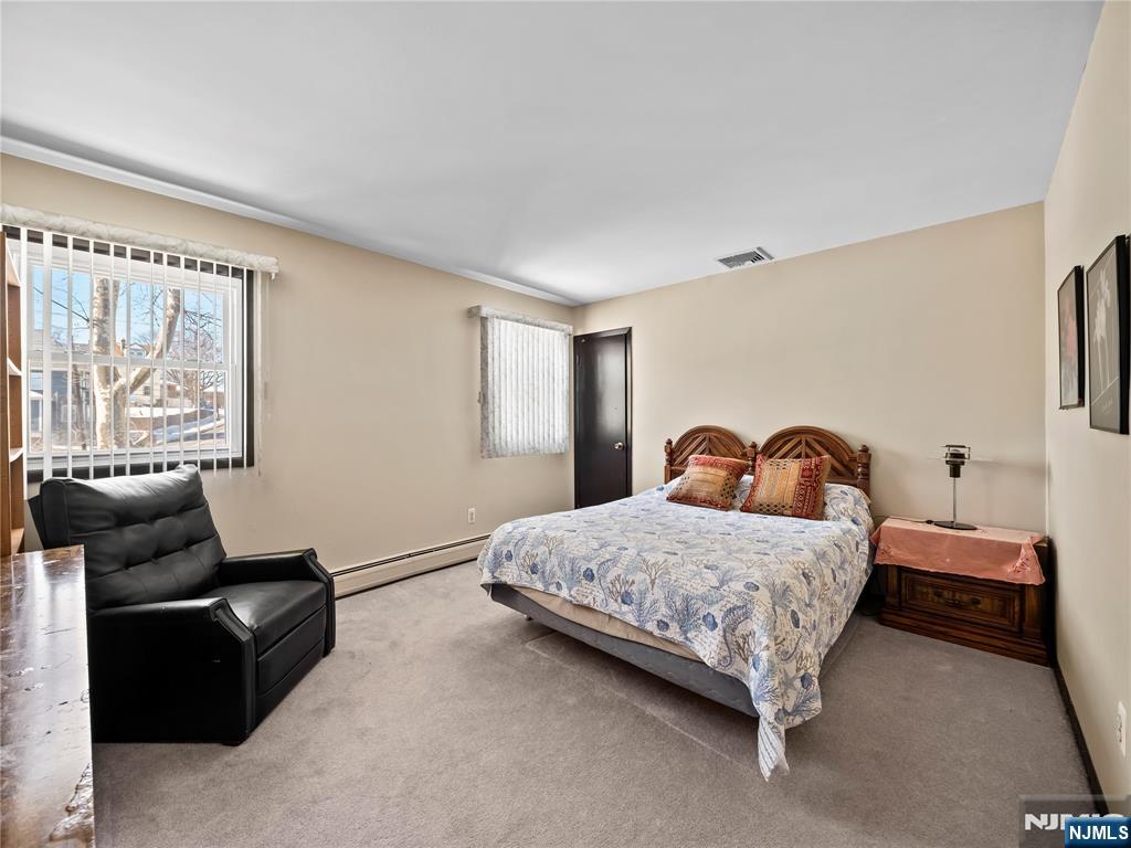 5 Woodland Road Bloomfield, NJ 07003 - Photo 12 of 30 a bedroom with a bed and a couch