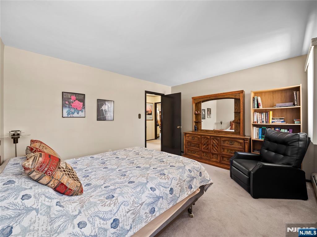 5 Woodland Road Bloomfield, NJ 07003 - Photo 13 of 30 a bedroom with a bed and dresser with mirror