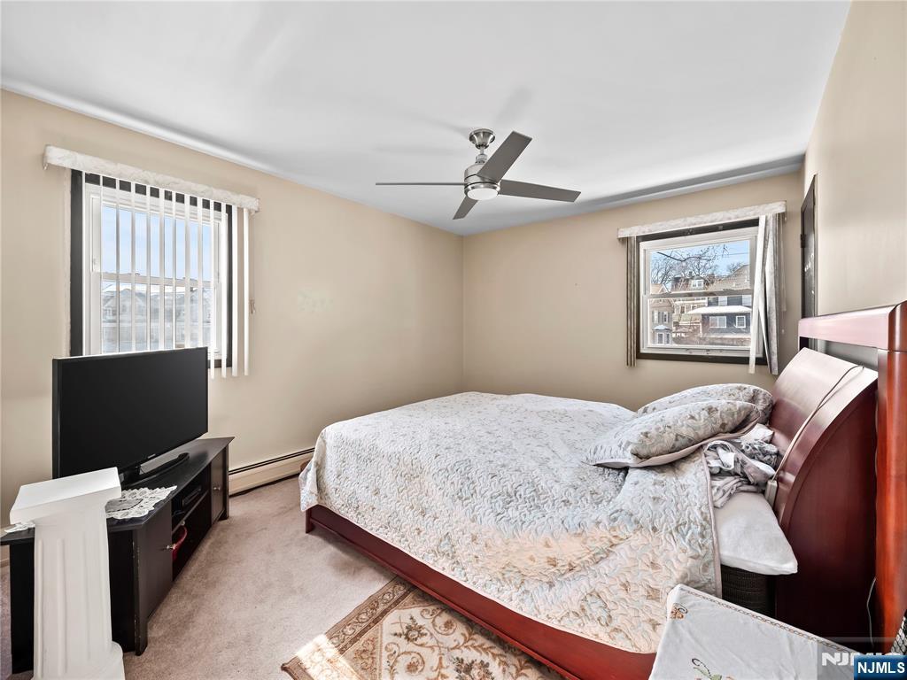 5 Woodland Road Bloomfield, NJ 07003 - Photo 14 of 30 a bedroom with a bed and a flat screen tv