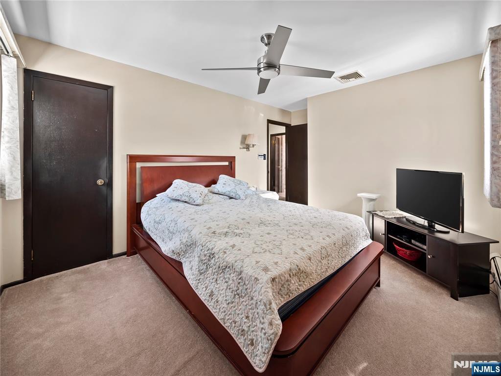 5 Woodland Road Bloomfield, NJ 07003 - Photo 15 of 30 a bedroom with a bed and a flat screen tv