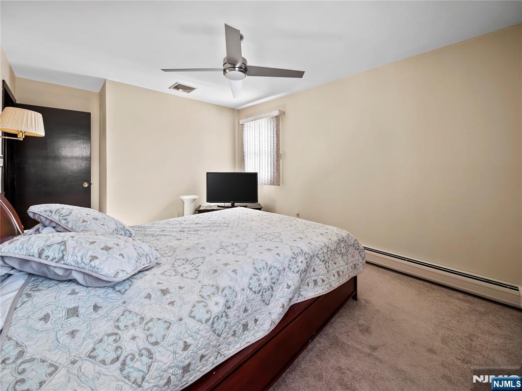 5 Woodland Road Bloomfield, NJ 07003 - Photo 16 of 30 a bedroom with a bed and a painting on the wall