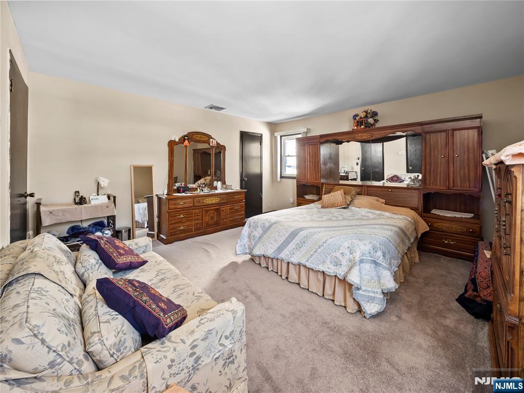 5 Woodland Road Bloomfield, NJ 07003 - Photo 17 of 30 a living room with furniture and a flat screen tv