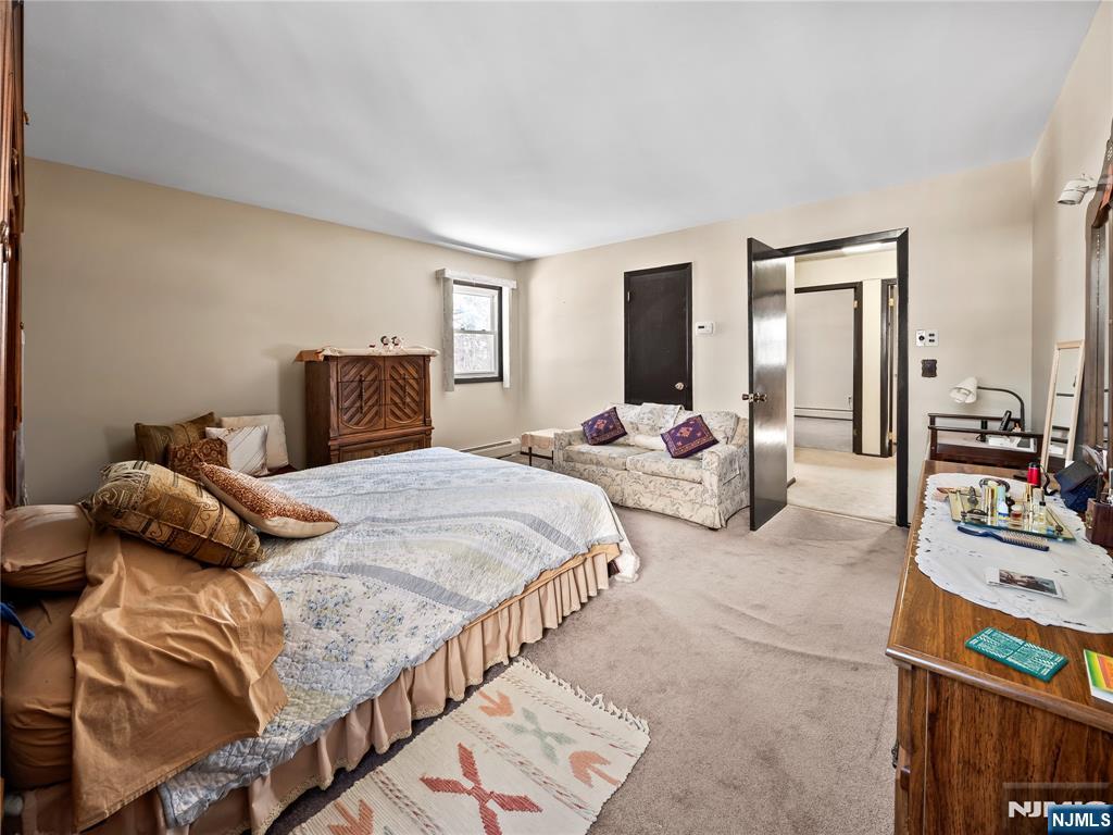 5 Woodland Road Bloomfield, NJ 07003 - Photo 18 of 30 a bedroom with double bed and a couch