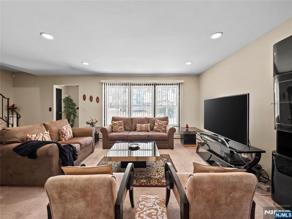 5 Woodland Road Bloomfield, NJ 07003 - Photo 2 of 30 a living room with furniture and a flat screen tv