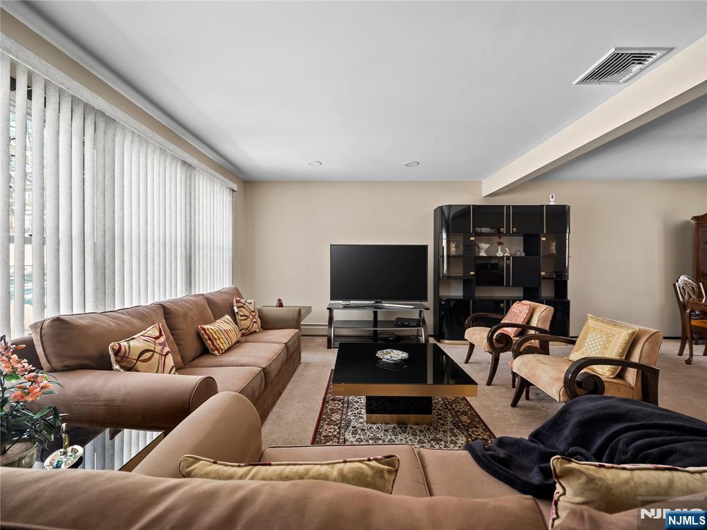 5 Woodland Road Bloomfield, NJ 07003 - Photo 3 of 30 a living room with furniture and a flat screen tv