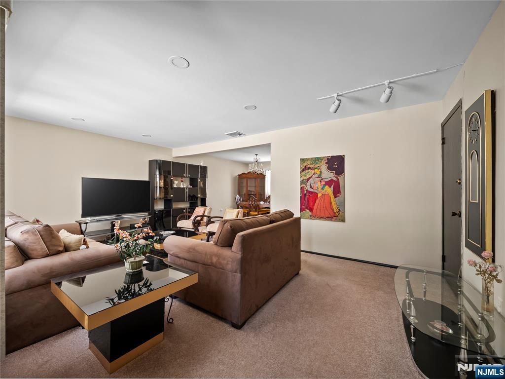 5 Woodland Road Bloomfield, NJ 07003 - Photo 4 of 30 a living room with furniture and a flat screen tv