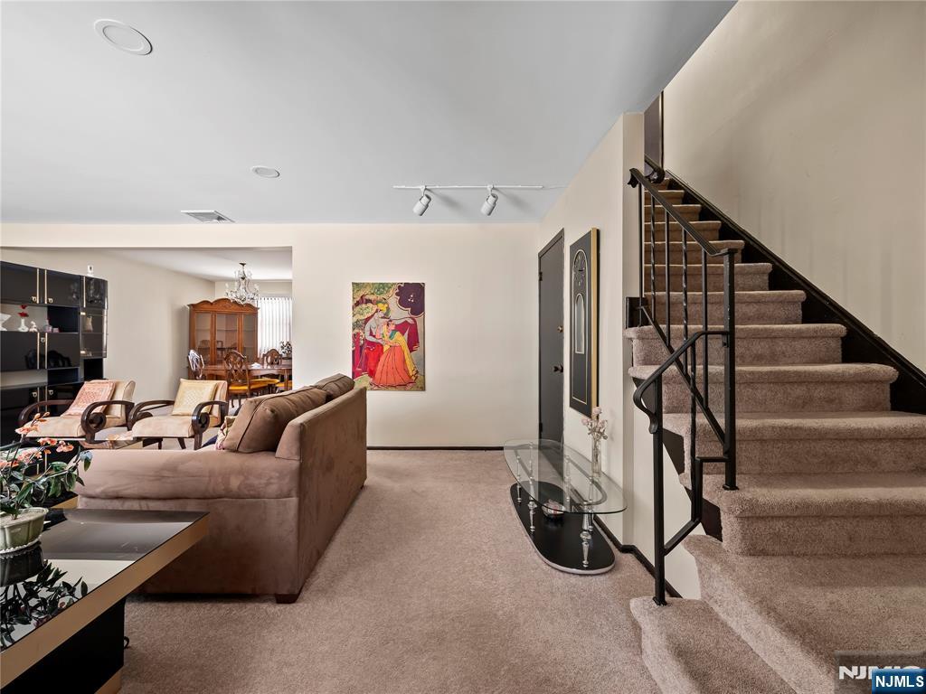 5 Woodland Road Bloomfield, NJ 07003 - Photo 6 of 30 a living room with furniture gym equipment and a view of entryway