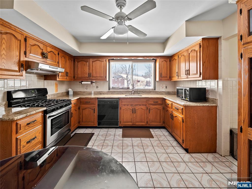 5 Woodland Road Bloomfield, NJ 07003 - Photo 9 of 30 a kitchen with a sink cabinets and window