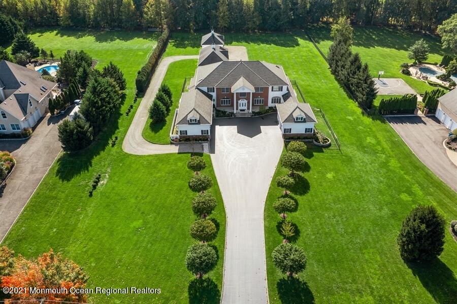 an aerial view of a house with a yard and lake view