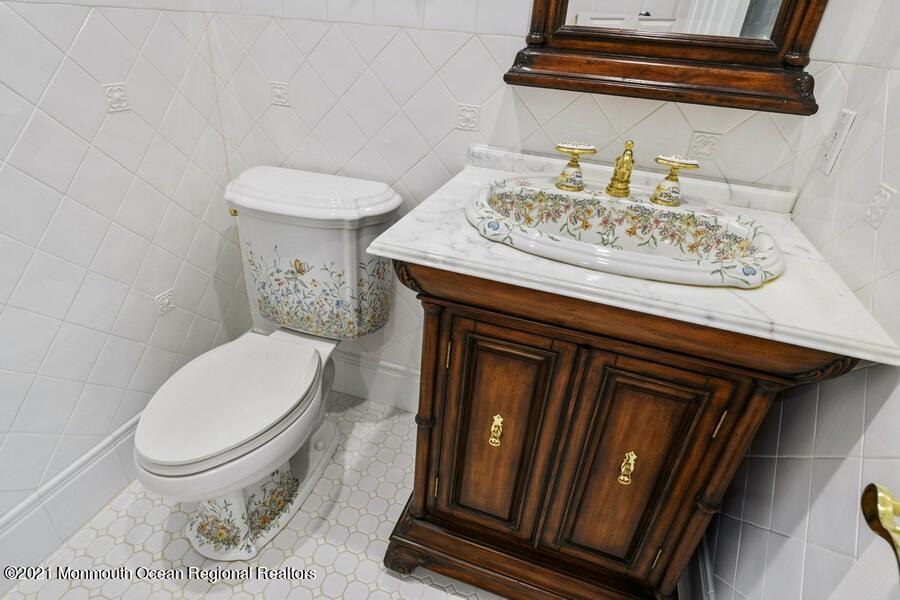 179 Stone Hill Road Colts Neck, NJ 07722 - Photo 11 of 57 a bathroom with a toilet and a sink