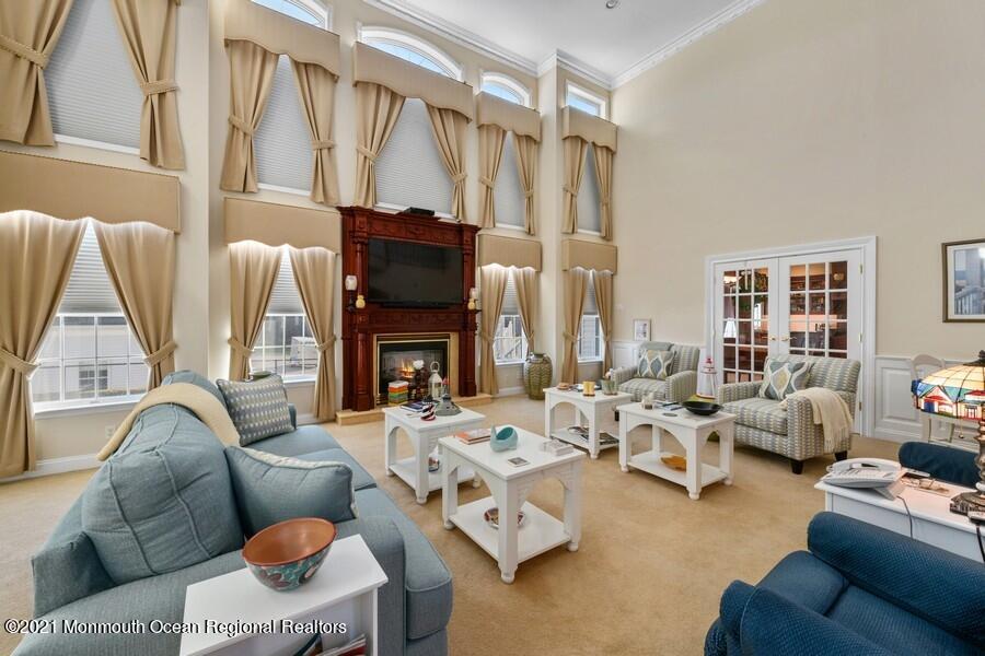 179 Stone Hill Road Colts Neck, NJ 07722 - Photo 12 of 57 a living room with furniture fireplace and a large window