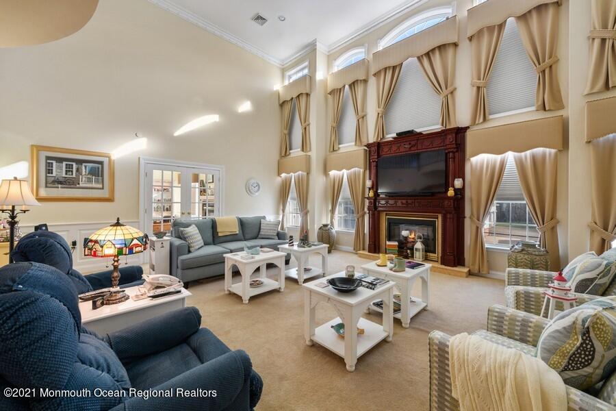 179 Stone Hill Road Colts Neck, NJ 07722 - Photo 13 of 57 a living room with furniture fireplace and a flat screen tv