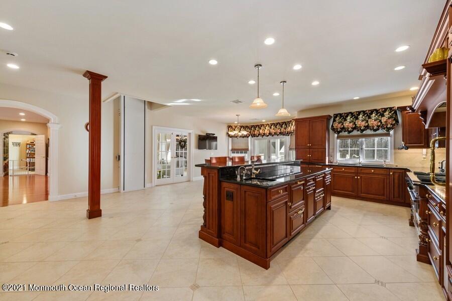 179 Stone Hill Road Colts Neck, NJ 07722 - Photo 17 of 57 a kitchen with stainless steel appliances granite countertop a stove and a refrigerator