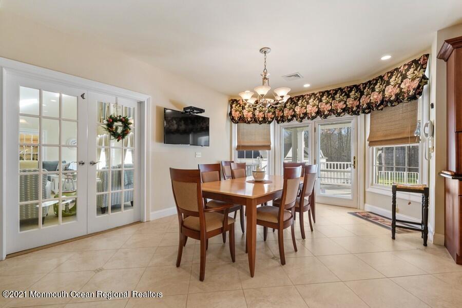 179 Stone Hill Road Colts Neck, NJ 07722 - Photo 19 of 57 a view of a dining room with furniture and chandelier