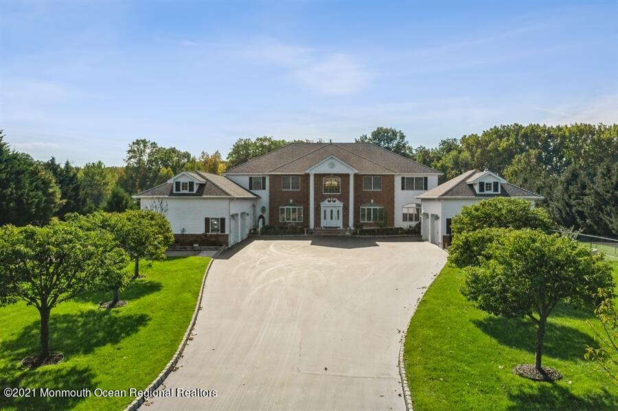 179 Stone Hill Road Colts Neck, NJ 07722 - Photo 2 of 57 a front view of a house with a garden