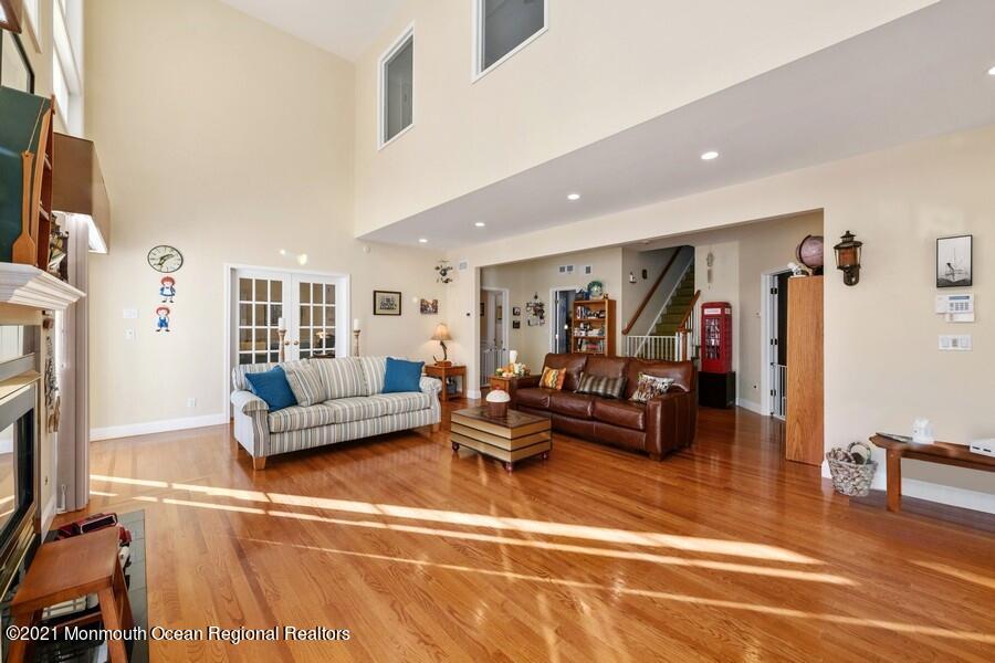 179 Stone Hill Road Colts Neck, NJ 07722 - Photo 22 of 57 a living room with furniture and a flat screen tv