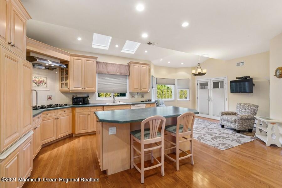 179 Stone Hill Road Colts Neck, NJ 07722 - Photo 25 of 57 a large kitchen with a table and chairs