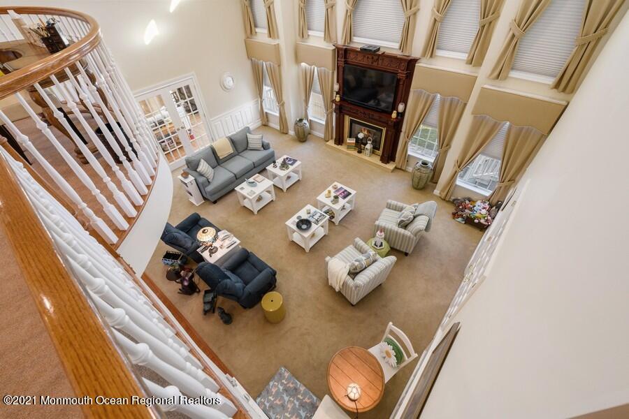 179 Stone Hill Road Colts Neck, NJ 07722 - Photo 27 of 57 a living room with furniture and floor to ceiling windows