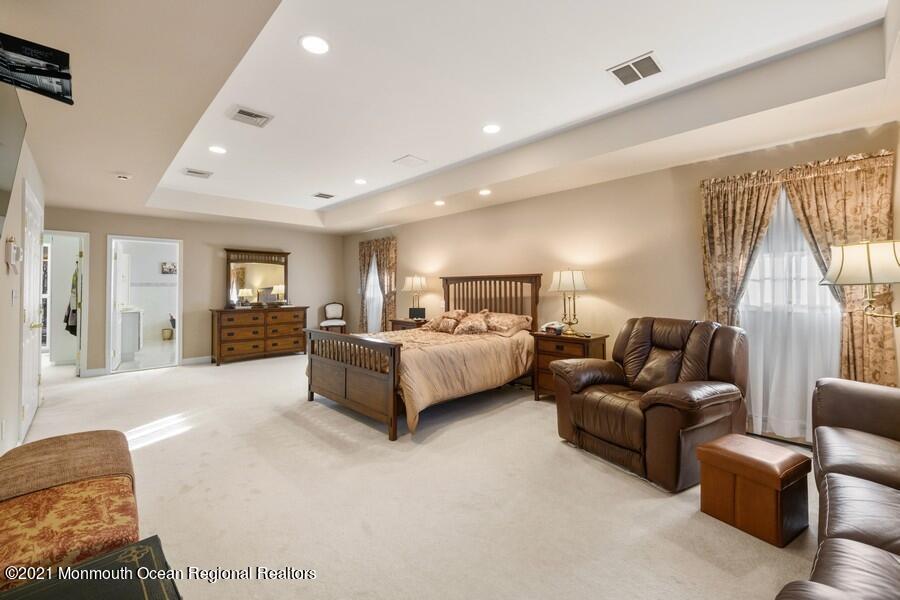 179 Stone Hill Road Colts Neck, NJ 07722 - Photo 33 of 57 a spacious bedroom with a bed and couch