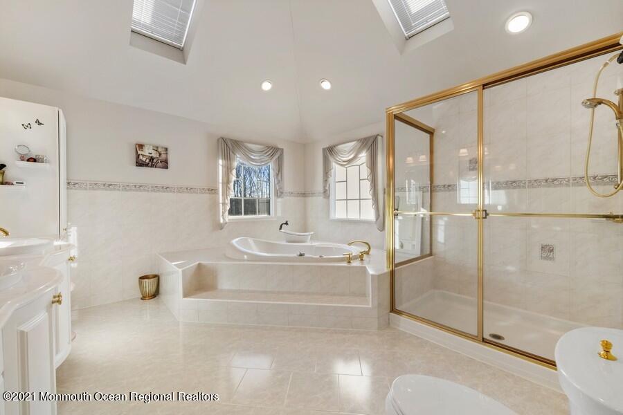 179 Stone Hill Road Colts Neck, NJ 07722 - Photo 36 of 57 a spacious bathroom with a tub shower sink and mirror