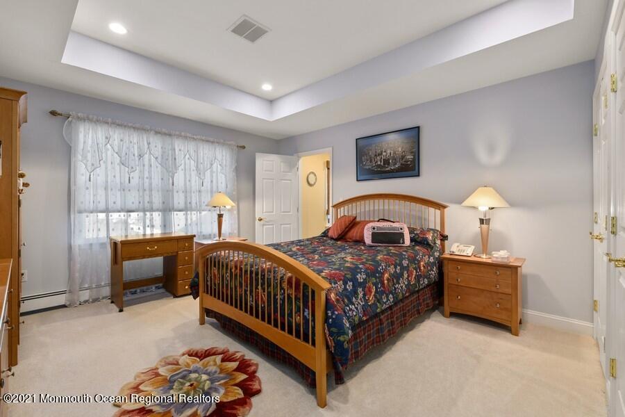 179 Stone Hill Road Colts Neck, NJ 07722 - Photo 37 of 57 a bedroom with a bed and a window