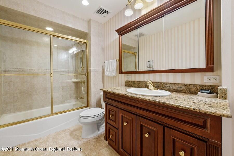 179 Stone Hill Road Colts Neck, NJ 07722 - Photo 38 of 57 a bathroom with a granite countertop sink a toilet a mirror and shower