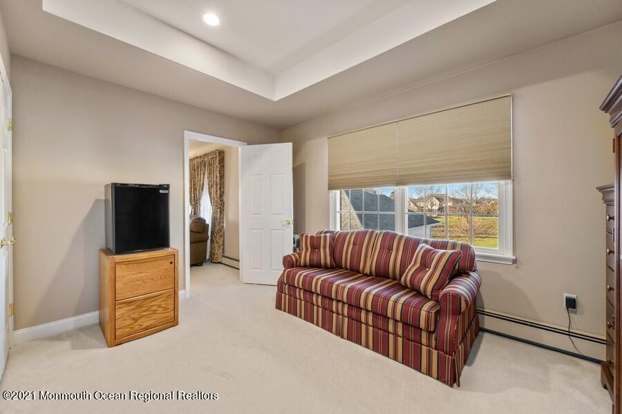 179 Stone Hill Road Colts Neck, NJ 07722 - Photo 39 of 57 a living room with furniture couch and a flat screen tv