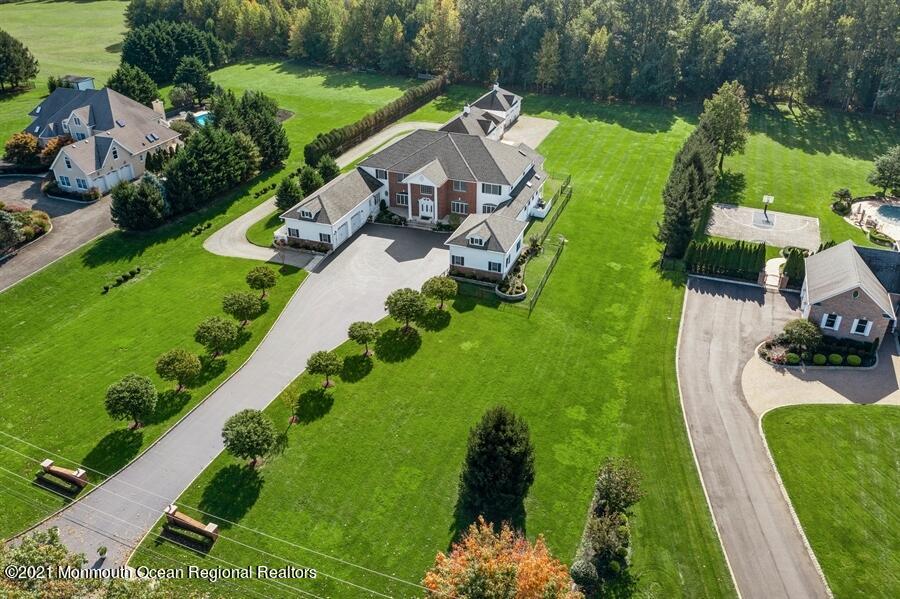 179 Stone Hill Road Colts Neck, NJ 07722 - Photo 45 of 57 an aerial view of a house with a garden and swimming pool