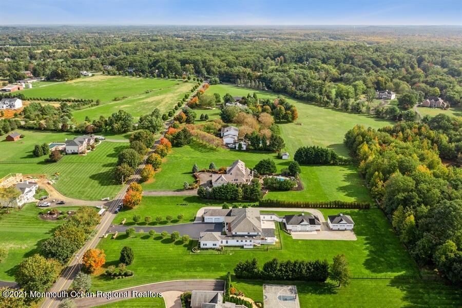 179 Stone Hill Road Colts Neck, NJ 07722 - Photo 46 of 57 an aerial view of residential houses with outdoor space and trees