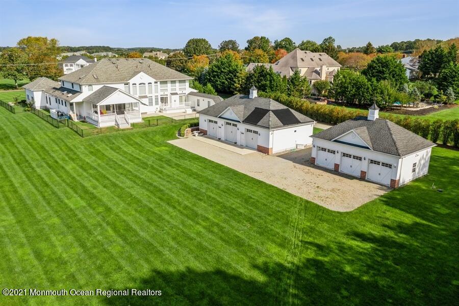 179 Stone Hill Road Colts Neck, NJ 07722 - Photo 5 of 57 an aerial view of a house with a big yard and large trees