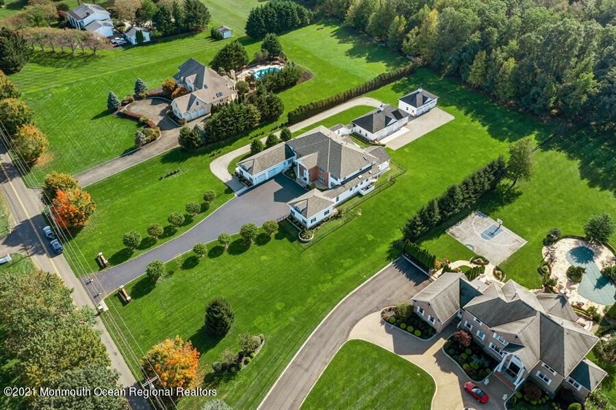 179 Stone Hill Road Colts Neck, NJ 07722 - Photo 52 of 57 an aerial view of a residential houses with outdoor space and street view