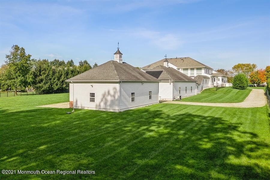 179 Stone Hill Road Colts Neck, NJ 07722 - Photo 55 of 57 a house with green field in front of it