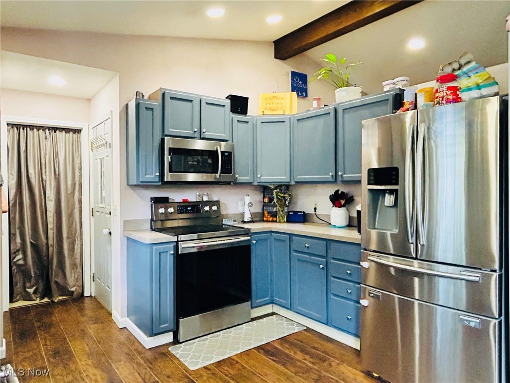 5636 Laskey Road Rome, OH 44085 - Photo 10 of 29 Kitchen featuring stainless steel appliances, light countertops, dark wood-style flooring, recessed lighting, and blue cabinets