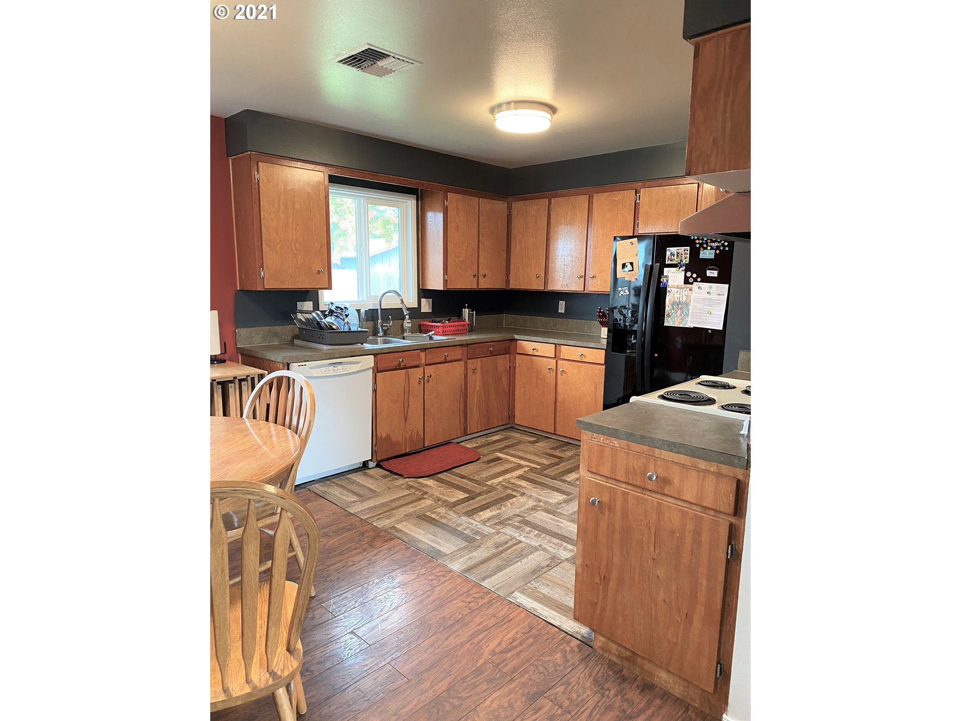 1070 N Street Springfield, OR 97477 - Photo 4 of 14 a kitchen with stainless steel appliances granite countertop a sink stove and refrigerator