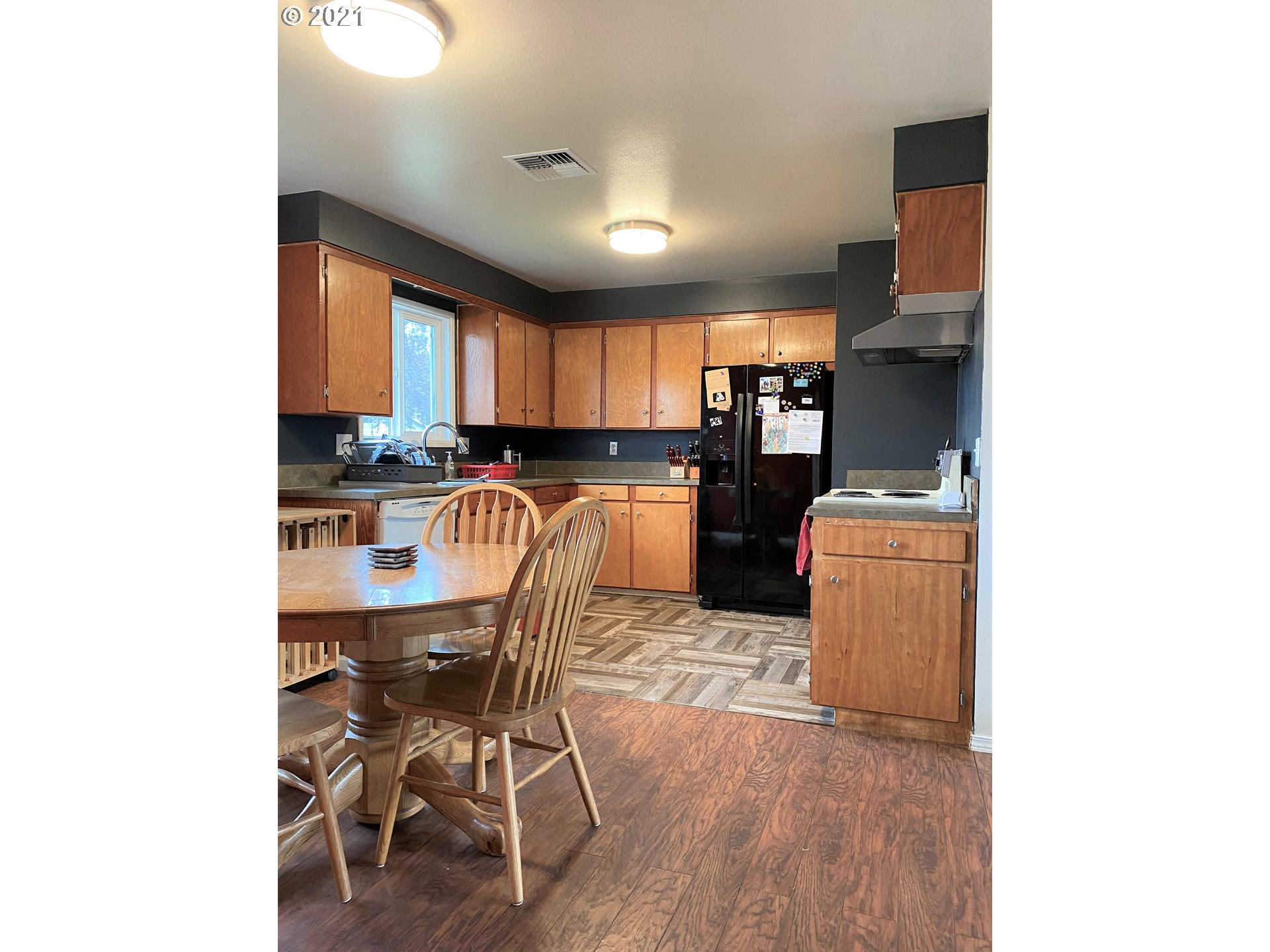 1070 N Street Springfield, OR 97477 - Photo 6 of 14 a kitchen with a table chairs refrigerator and microwave